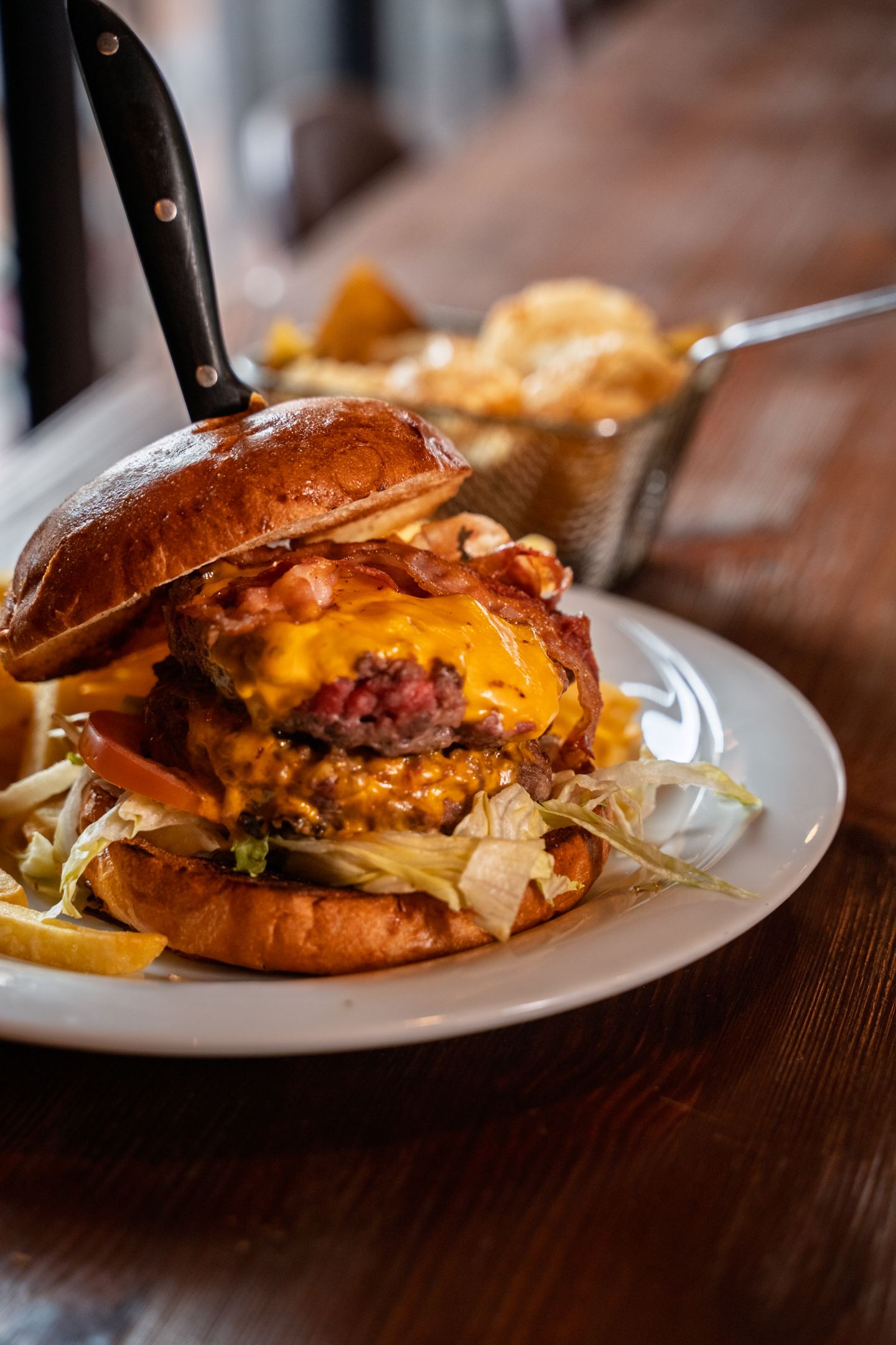 A local beef burger with melted cheddar and fries at Corner 52